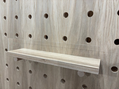 Oak veneer shelf with acrylic up stand on pegboard by Kreisdesign
