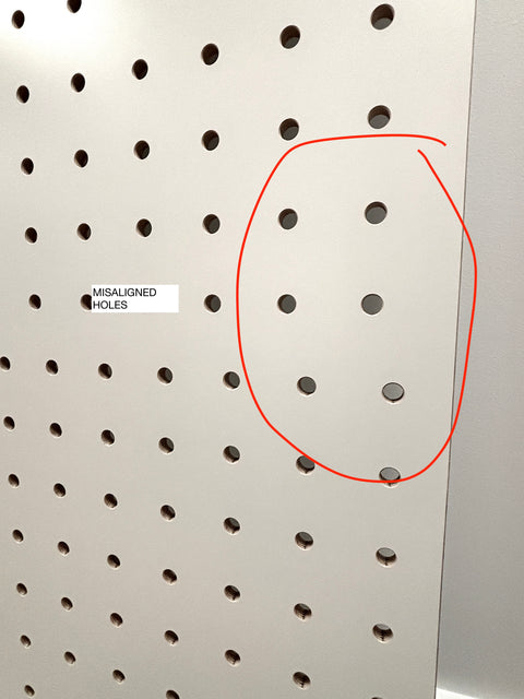 Pegboard with misaligned holes highlighted by a red circle and text label.