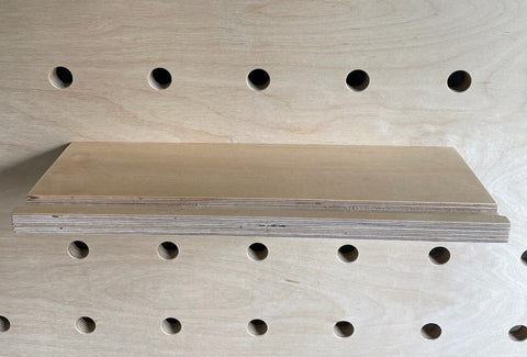 plywood shelf with groove - groove prevents picture frame to slid off