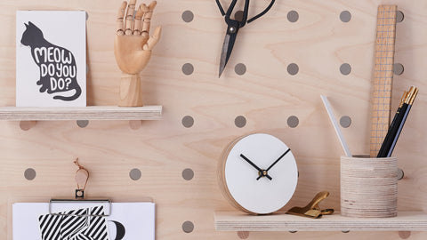 large wood pegboard with shelves pegs
