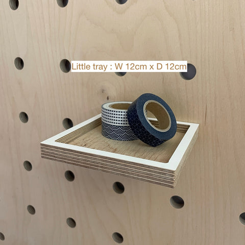 Small wooden tray fitted with pegs for pegboard