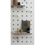 white pegboard with shelves and pegs