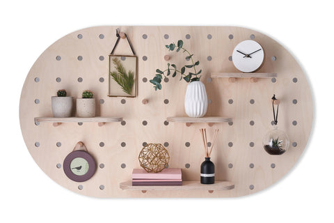 large oval shaped wood pegboard with shelves and hooks made by kreisdesign