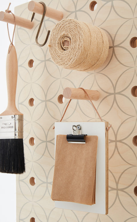 mini clipboard hanging on wooden peg slot into plywood pegboard by kreisdesign