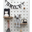 large white wooden pegboard with peg hooks and shelves in kids room 
