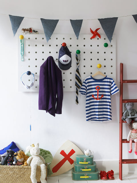 large wood white pegboard in kids room with colour pegs