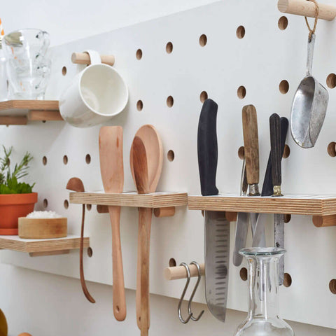 white wooden utensil holder for pegboard