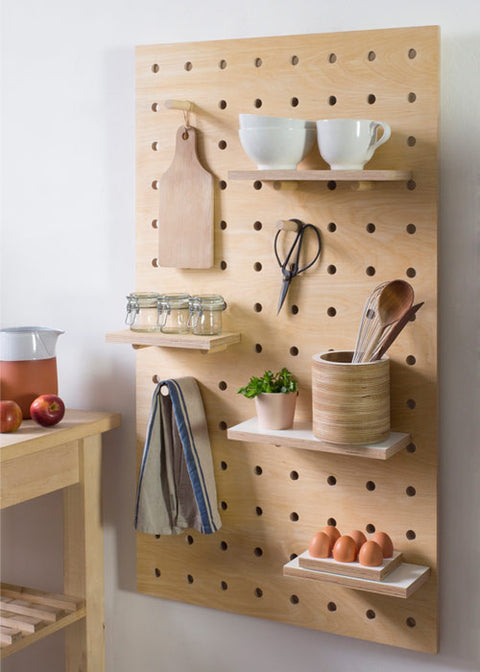 Large wooden pegboard with shelves and pegs made from birch plywood by Kreisdesign