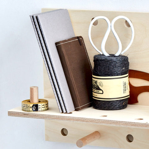 wooden bookshelf with pegs