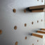 black painted pegboard showing the wood grain slightly visible through the paint - by Kreisdesign 