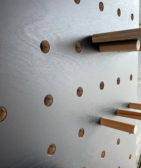 black painted pegboard showing the wood grain slightly visible through the paint - by Kreisdesign 