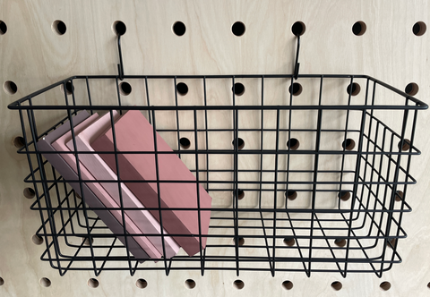 black wire basket for pegboard with books