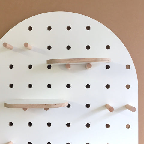 white lozenge pegboard with shelves and pegs