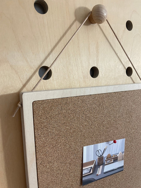 detail of plywood and cork notice board A4 size for pegboards with leather string to hang from peg