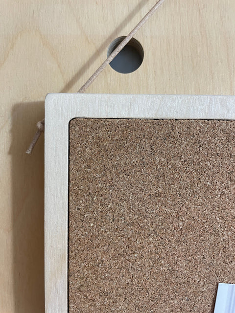 detail plywood cork pin board - frame edge with leather string to hang from pegboard