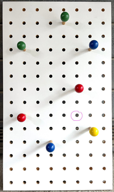 white pegboard with coloured pegs by Kreisdesign