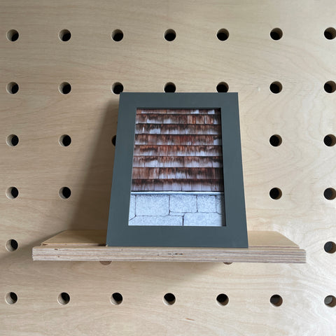 pegboard shelf with groove for frames book display by kreisdesign