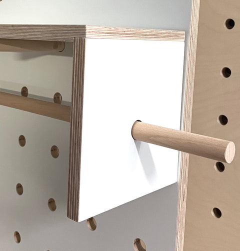 white kraft paper roll holder for pegboard, with beech rod. Can also be used to hang ribbons, washi tapes or other craft items