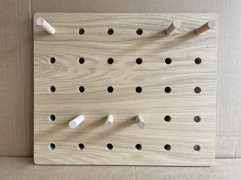 oak veneer pegboard with pegs by kreisdesign