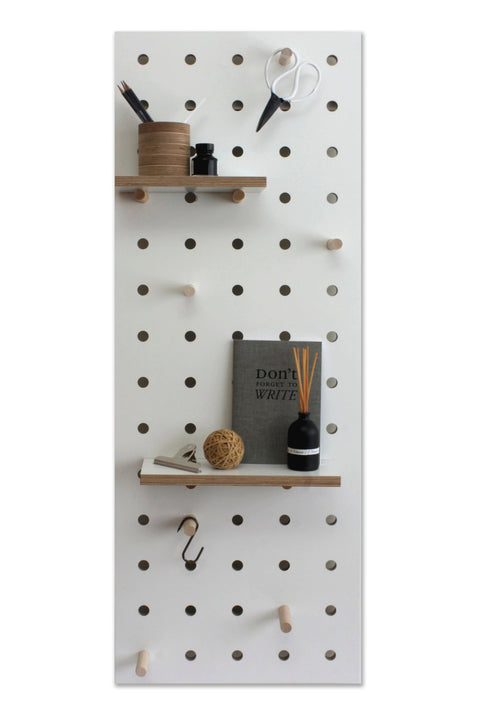 white pegboard with shelves and pegs