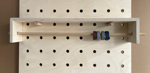 Wrapping paper / Kraft paper roll holder with shelf for pegboards by Kreisdesign. Also work for Washi tape or craft ribbons etc