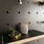 black painted pegboard in birch plywood detail with shelf and accessories