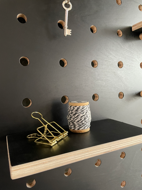 black painted pegboard in birch plywood detail with shelf and accessories