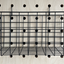 black wire basket hanging from hooks off pegboard by kreisdesign