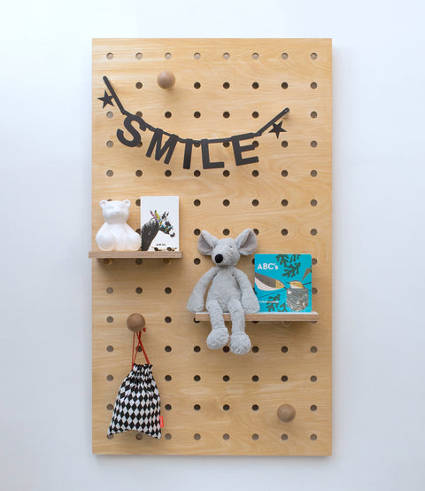 Large wooden pegboard made from highest quality plywood in kids room 