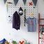 large wood white pegboard in kids room with colour pegs 