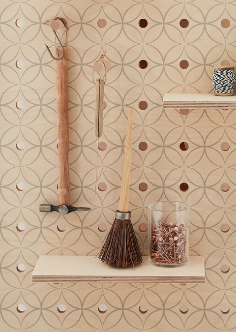 hanging hammer and nails on wooden pegboard with wooden shelf and solid pegs