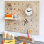 wood pegboard small above a desk to store pens, books, etc