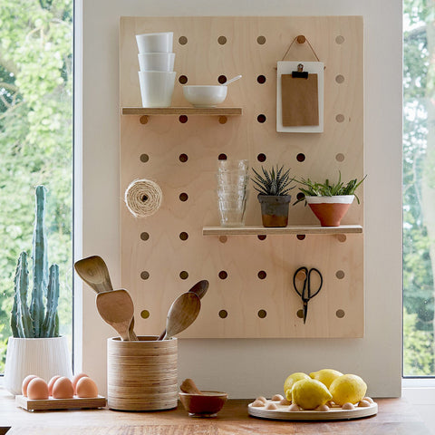 wood pegboard in kitchen with shelves and pegs