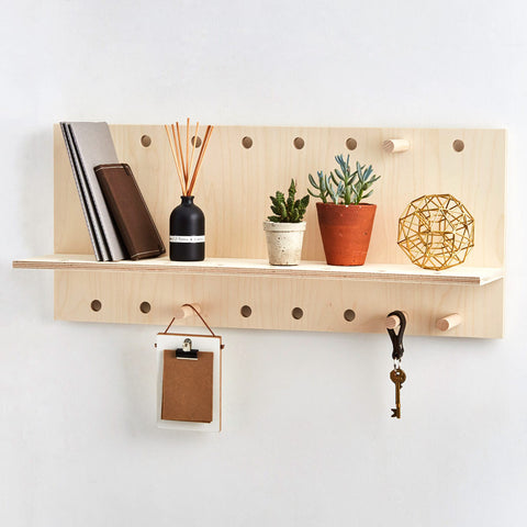 large wall shelf in wood with hanging storage pegs