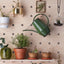 plywood pegboard plant pots on shelf and watering can on peg