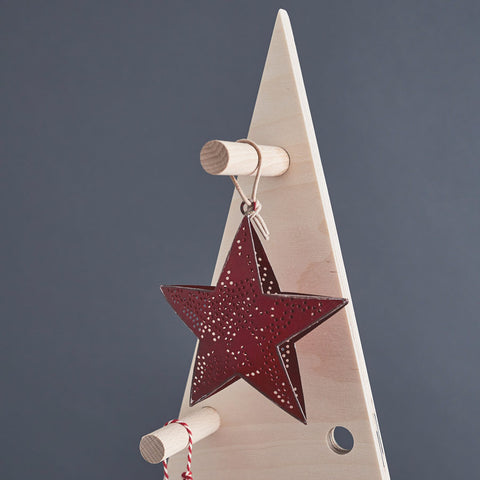 detail of top of wooden xmas trees with pegs and hanging star